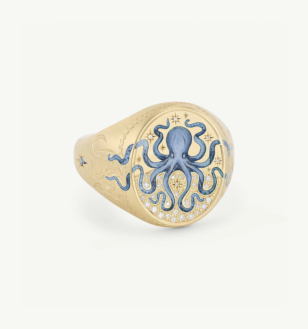 Gold ring featuring an engraved octopus design with blue enamel and star motifs.