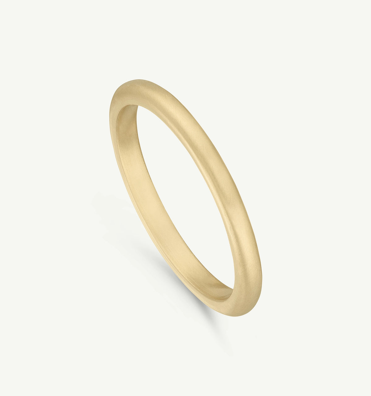 Gold ring with a matte finish displayed against a minimalistic background.