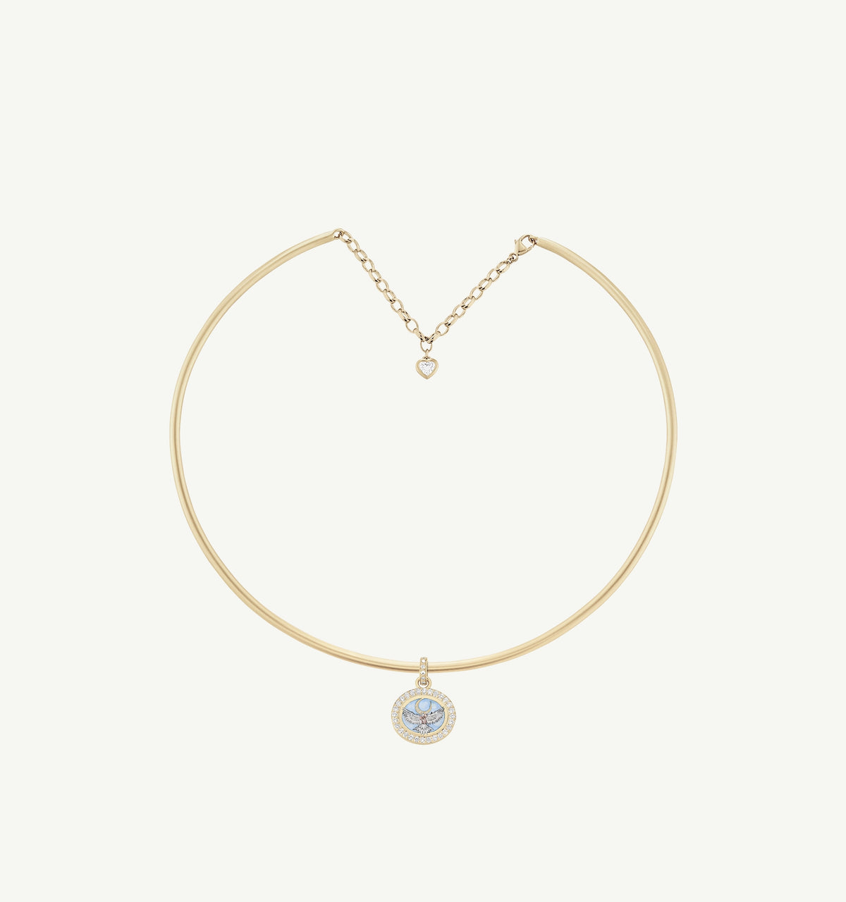 Gold necklace with a circular pendant featuring blue enamel and a heart charm.