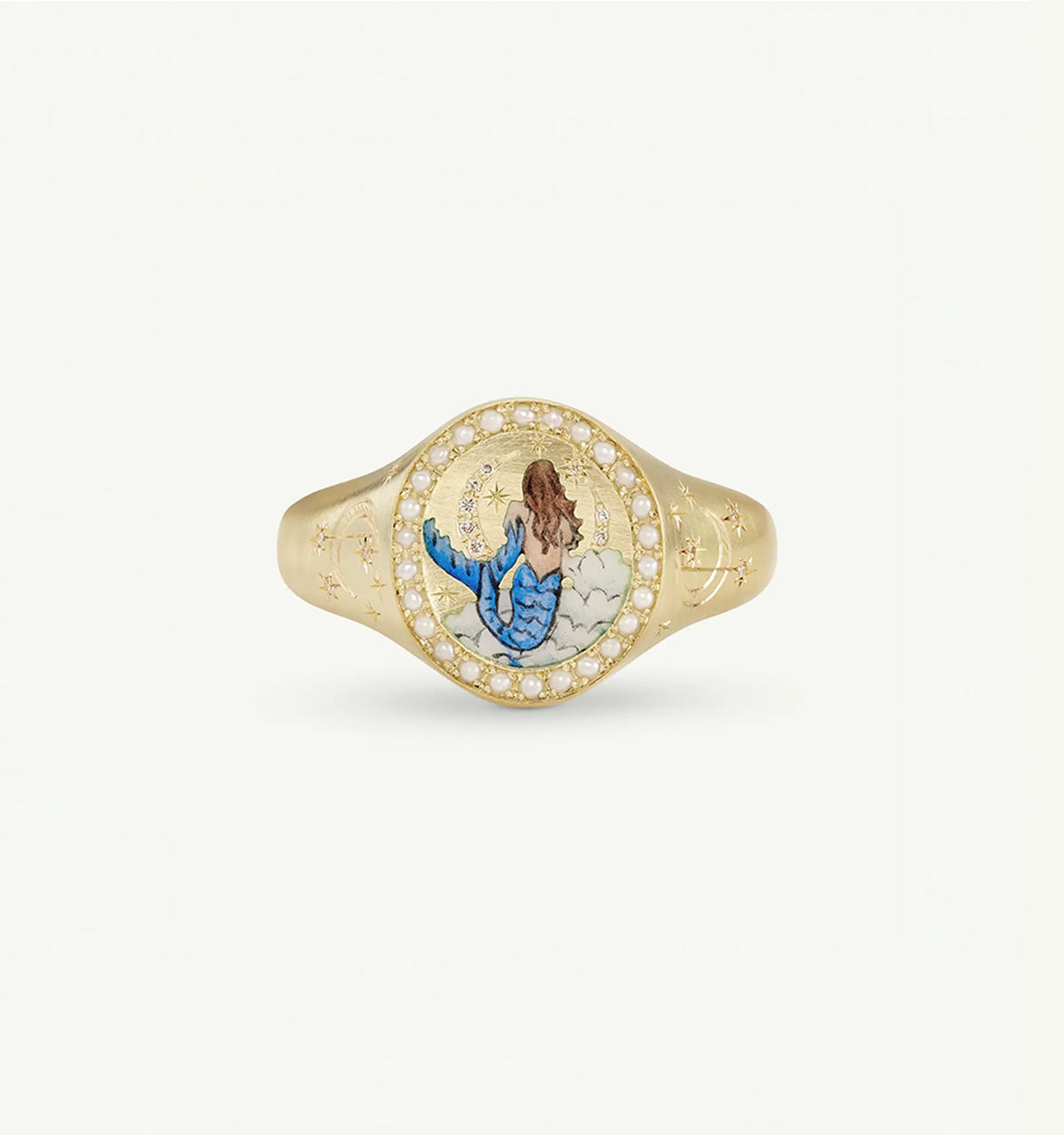 Gold ring featuring an enamel mermaid design surrounded by a halo of pearls and star engravings.
