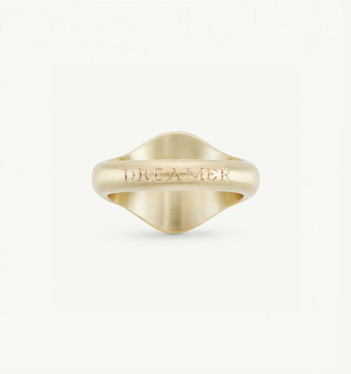 Gold ring featuring an engraved "DREAMER" inscription on a rounded band.