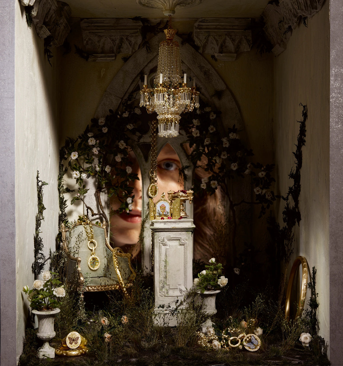 Display of gold jewellery including a necklace with a flower motif and a ring, surrounded by floral decor.