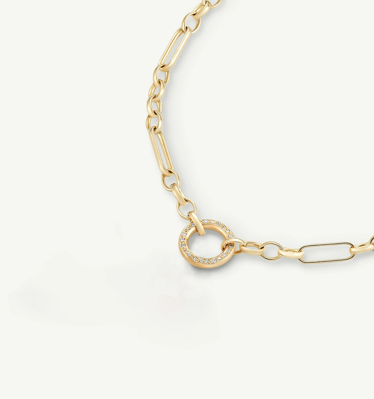 Gold chain necklace featuring a circular pendant with a ring of diamonds.