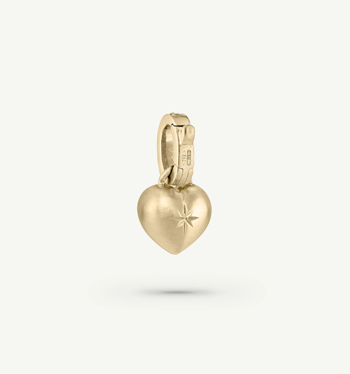 Gold heart pendant featuring a star engraving, suspended from a gold bail with a smooth finish.