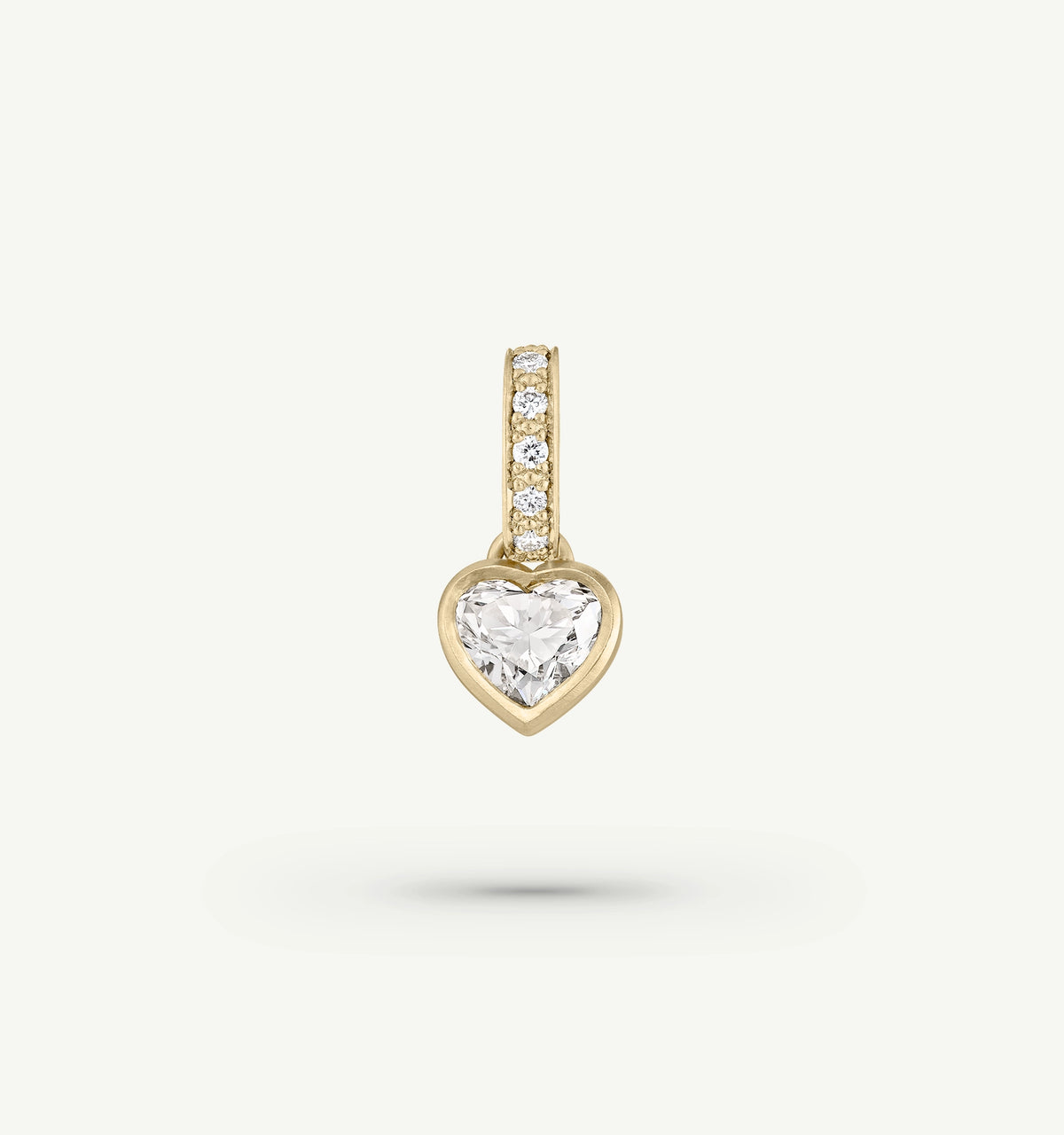 Heart-shaped gold pendant featuring a large diamond and smaller diamonds along the bail.