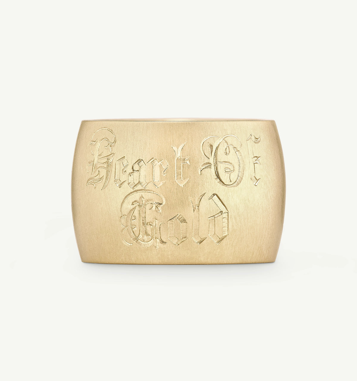 Heart of Gold gold cuff bracelet featuring engraved lettering.