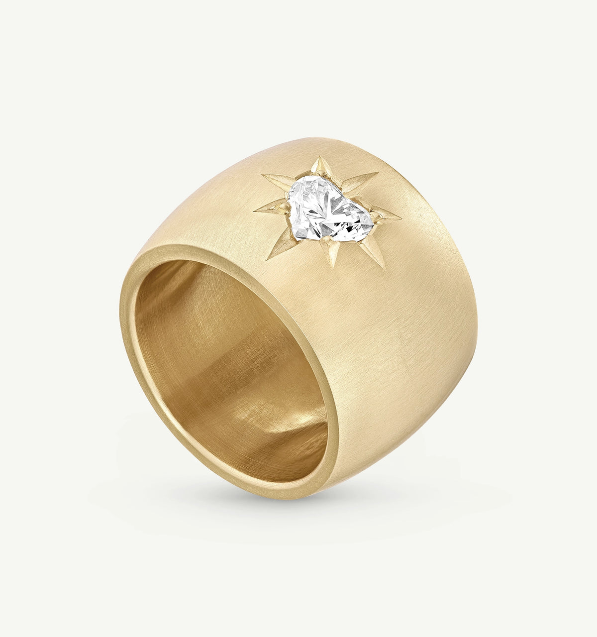Gold ring featuring a heart-shaped diamond with a sunburst design.