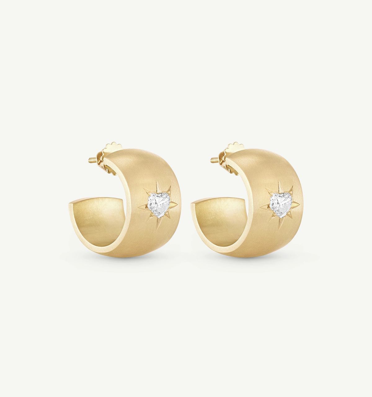 Gold hoop earrings featuring heart-shaped diamonds and star engravings.