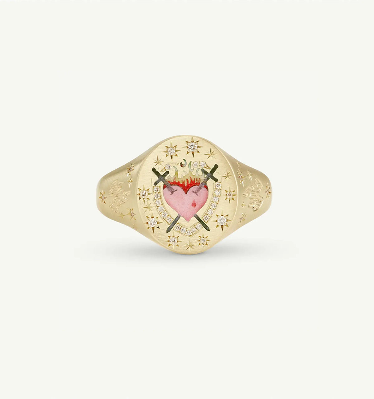 Gold ring featuring a heart motif with two crossed swords and star engravings.