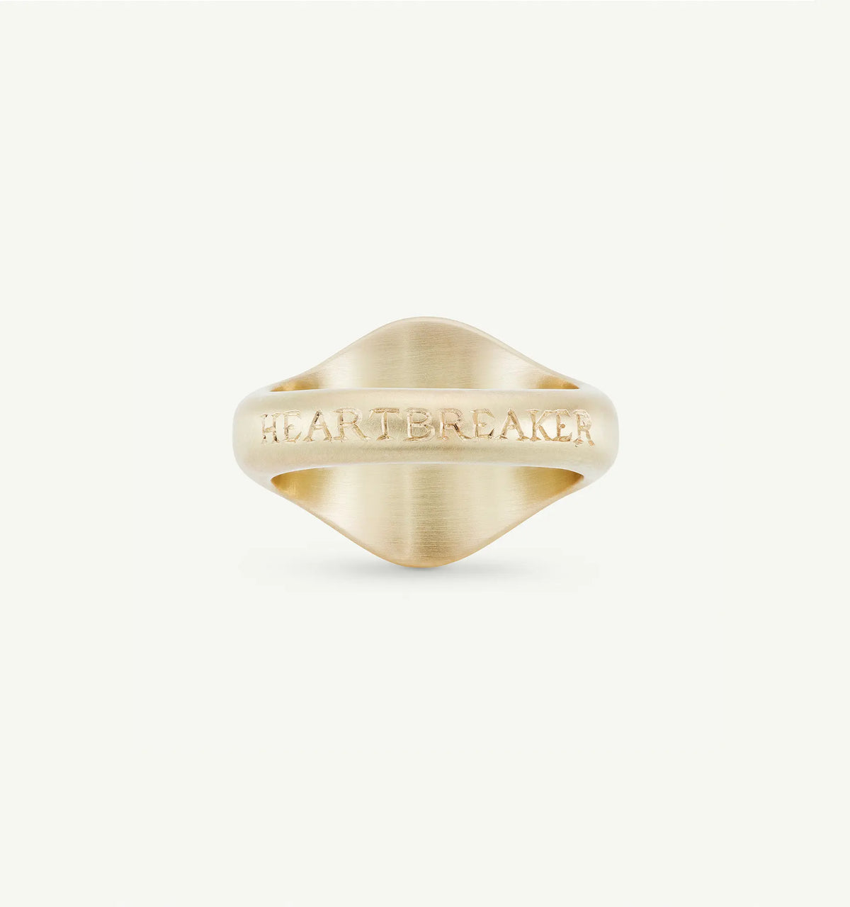 Gold ring featuring an engraved "HEARTBREAKER" detail on a smooth, curved band.