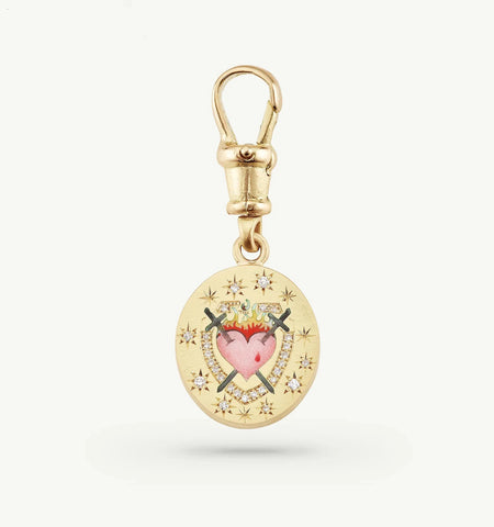 Gold charm featuring a heart design, crossed swords, and small diamonds set in a star pattern.