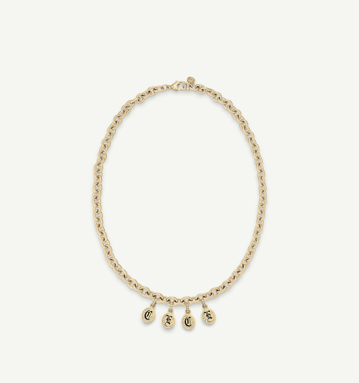 Gold chain necklace with four pendants featuring initials in black enamel.