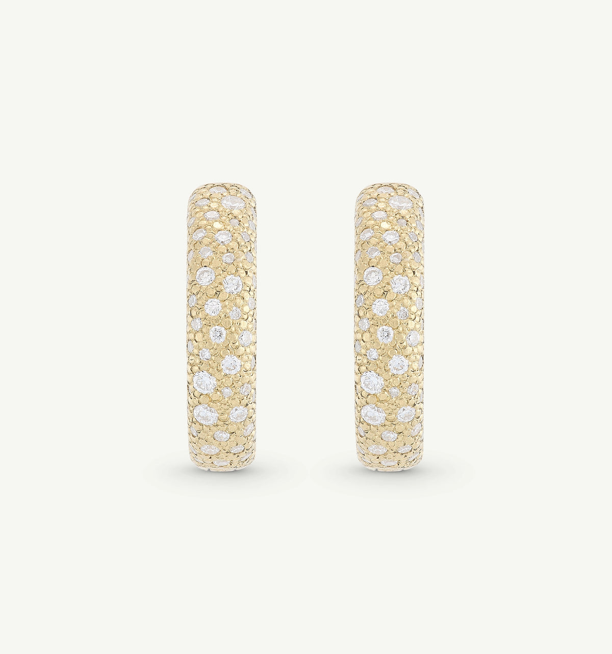 Gold hoop earrings featuring pavé-set diamonds.