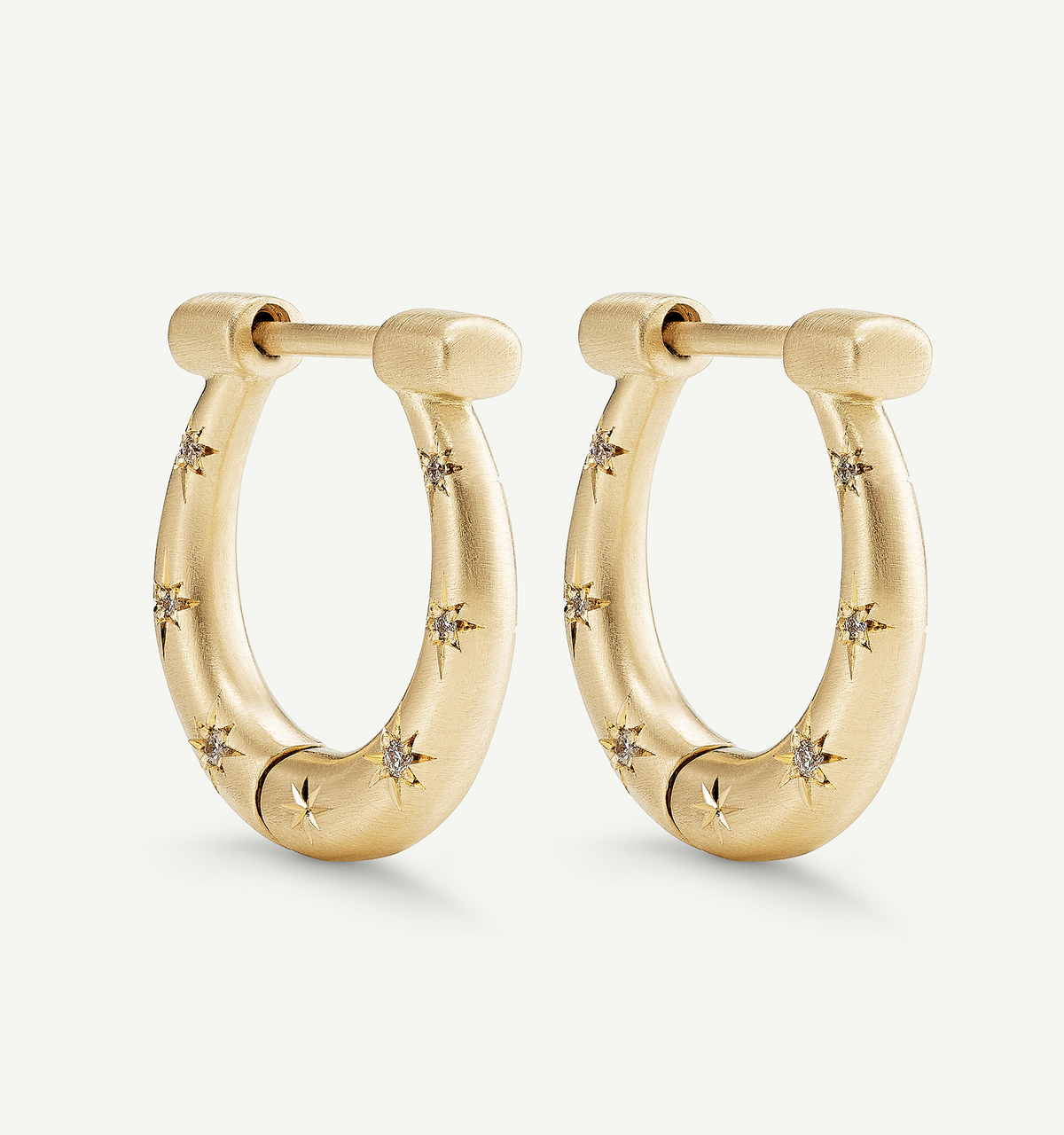 Gold hoop earrings featuring star motifs with diamonds.