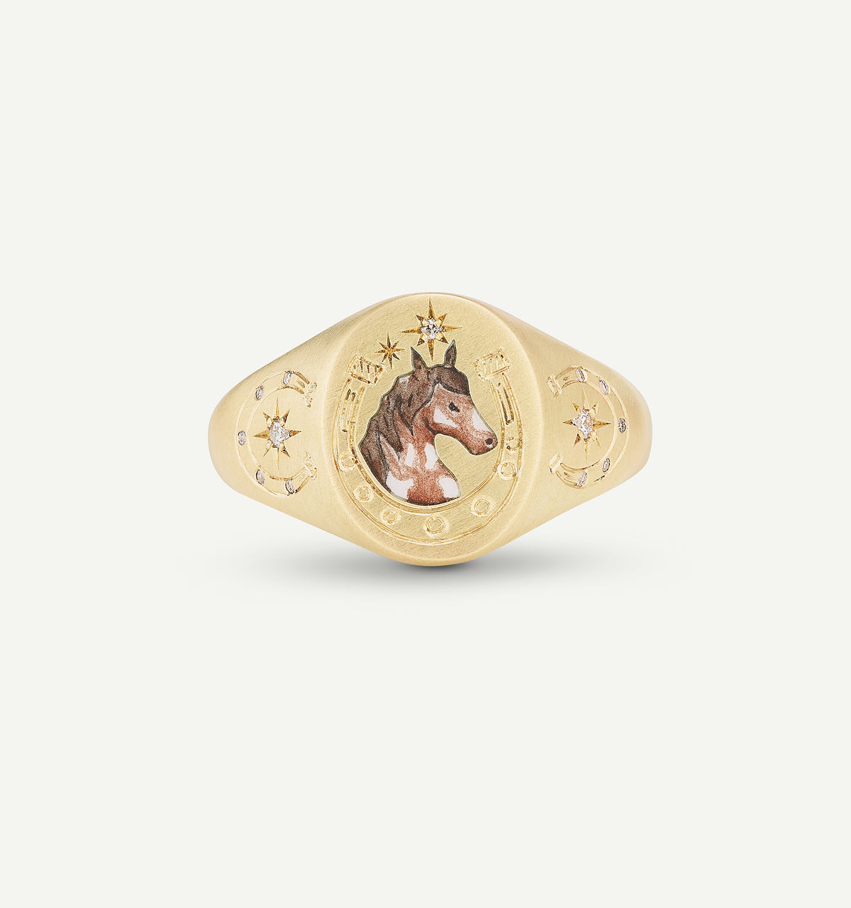 Gold signet ring featuring a horse motif in enamel and small diamonds set in a circular design.