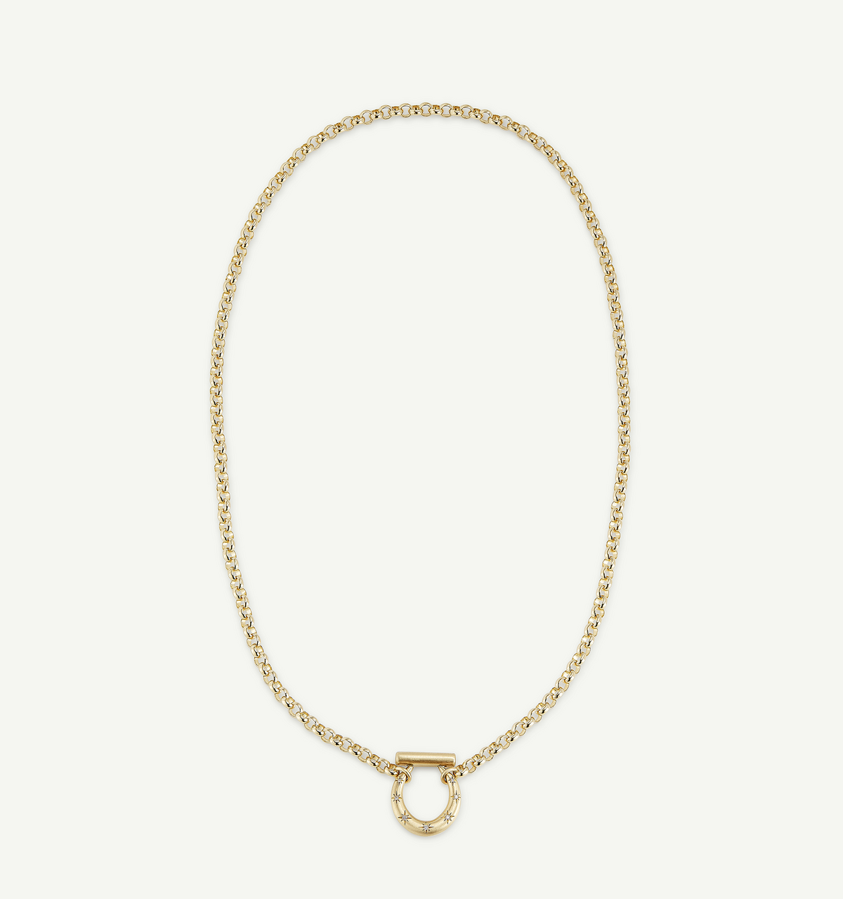 Gold chain necklace featuring a circular toggle clasp with star engravings.