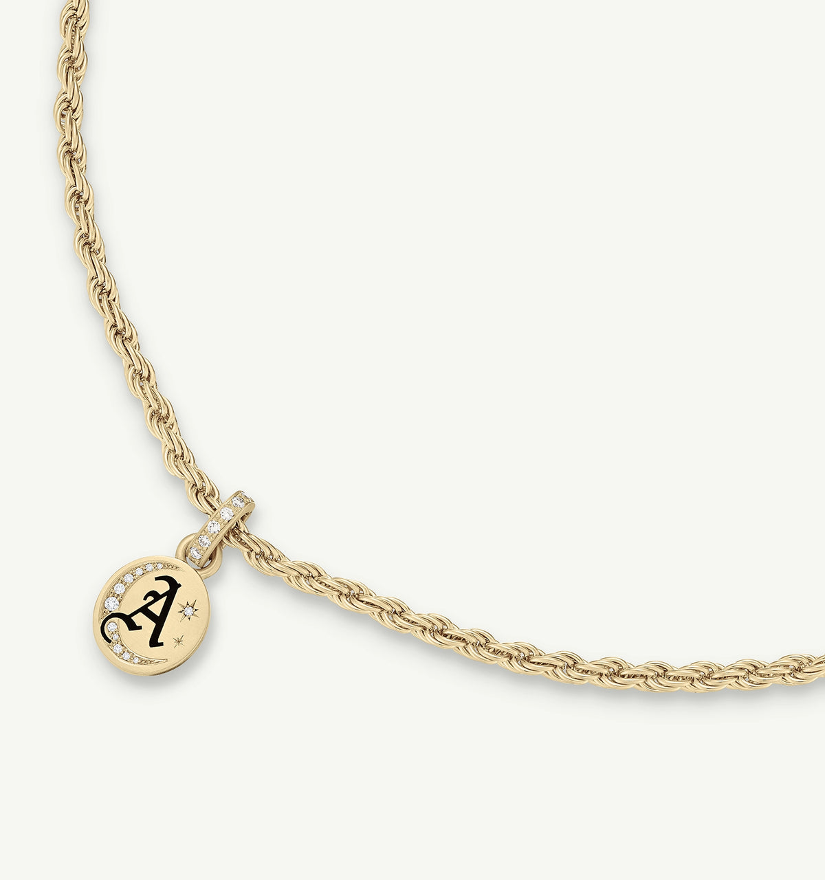 Gold necklace with a braided chain and a round pendant featuring an engraved letter "A" and small diamonds.