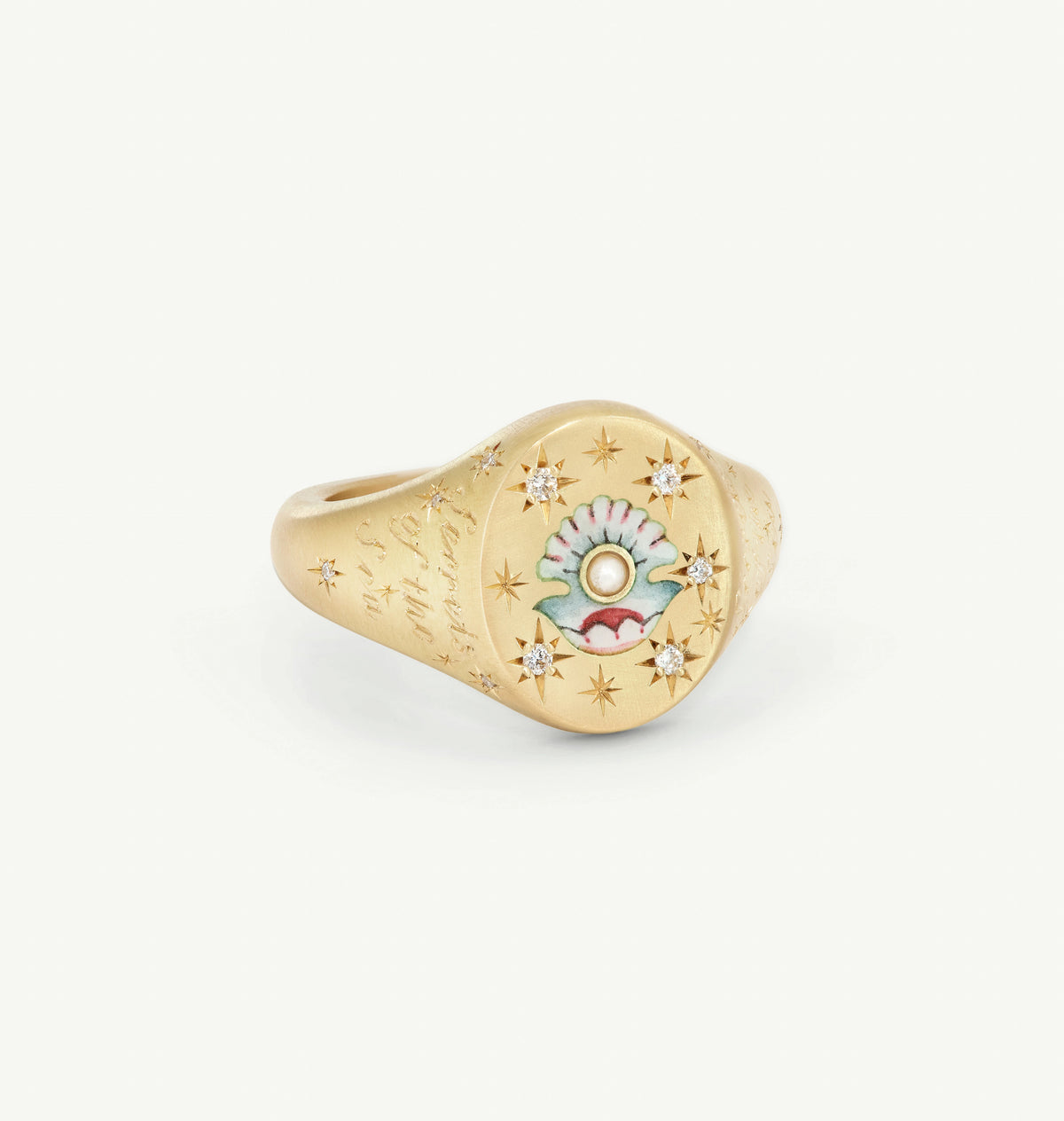 Gold signet ring featuring enamel shell design and five small diamonds.