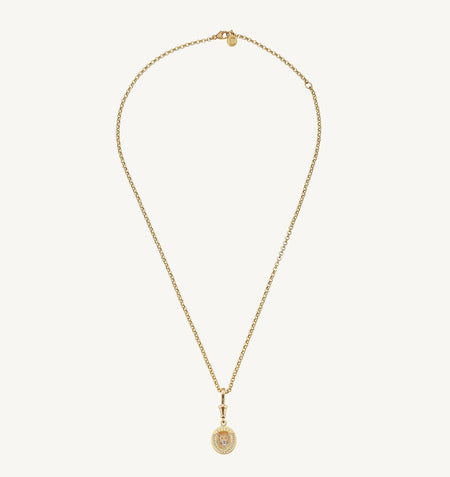 Gold necklace featuring a shield-shaped pendant with diamonds on a delicate chain.