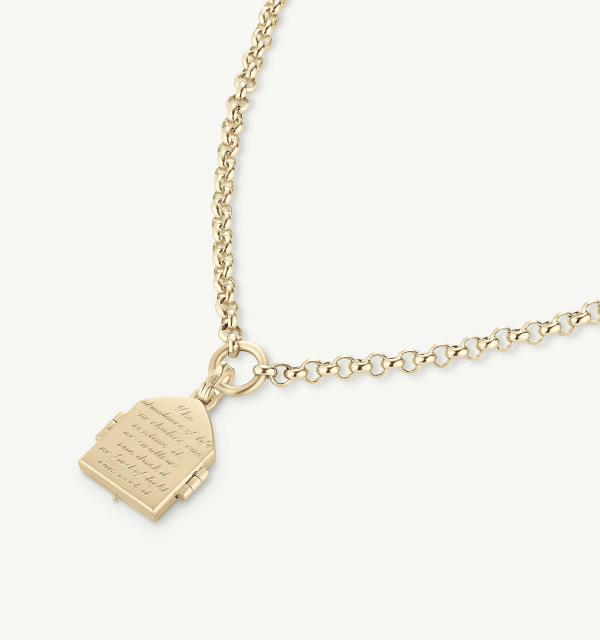 Gold necklace featuring an engraved pendant shaped like a book on a chain.