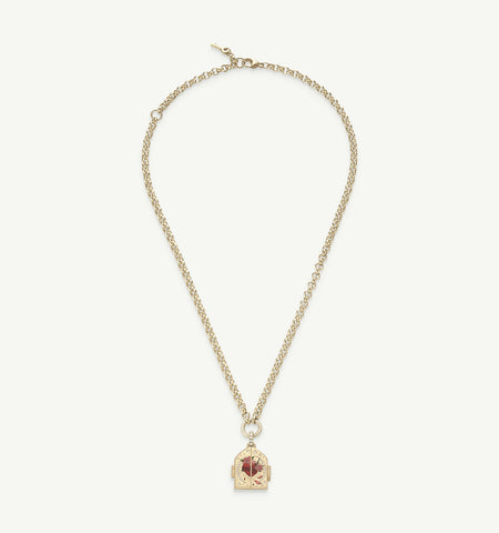 Gold necklace featuring an ornate pendant with red and pink enamel motifs on a chain.