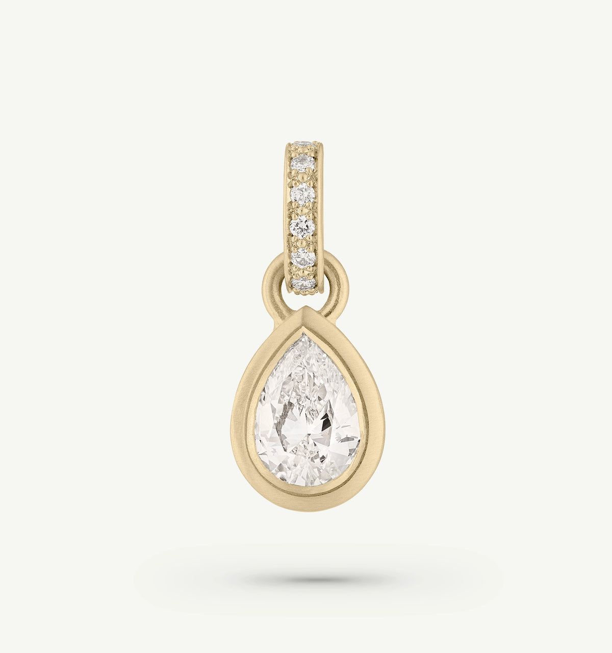 Gold pendant featuring a pear-shaped diamond surrounded by smaller diamonds.