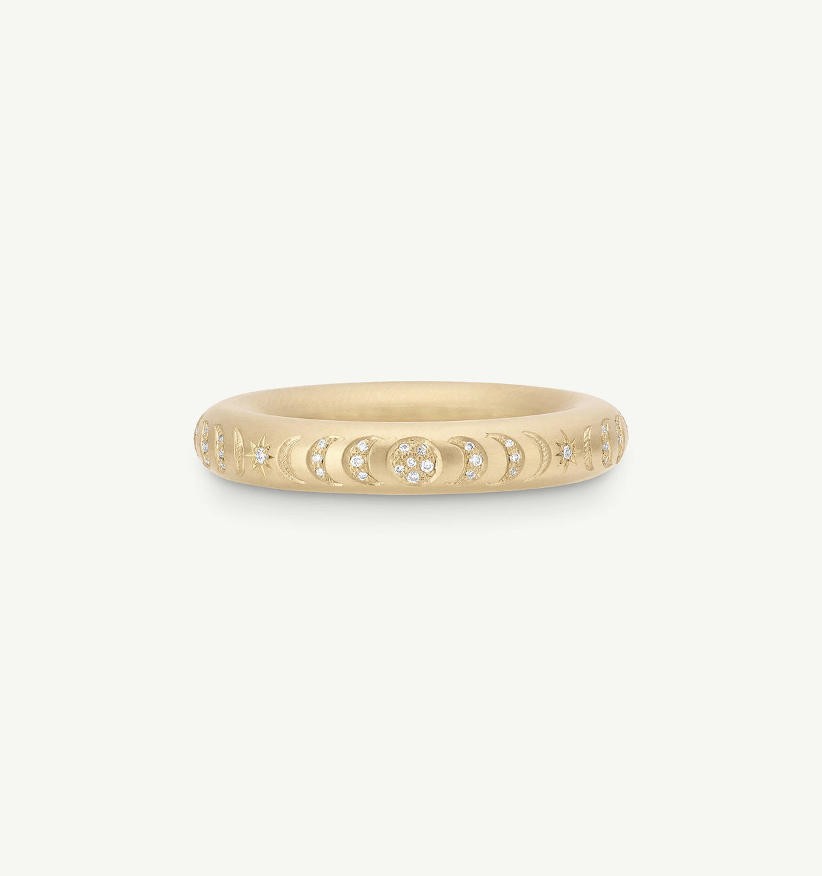 Gold ring featuring engraved celestial motifs and round diamonds.