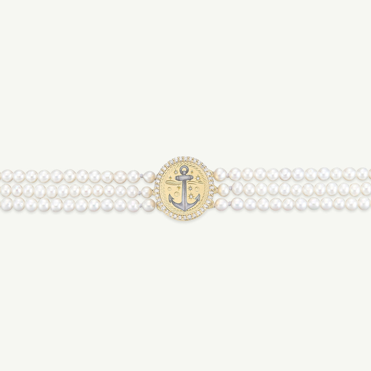 Gold bracelet with a central anchor motif, featuring a cluster of pearls and a diamond-encrusted frame.