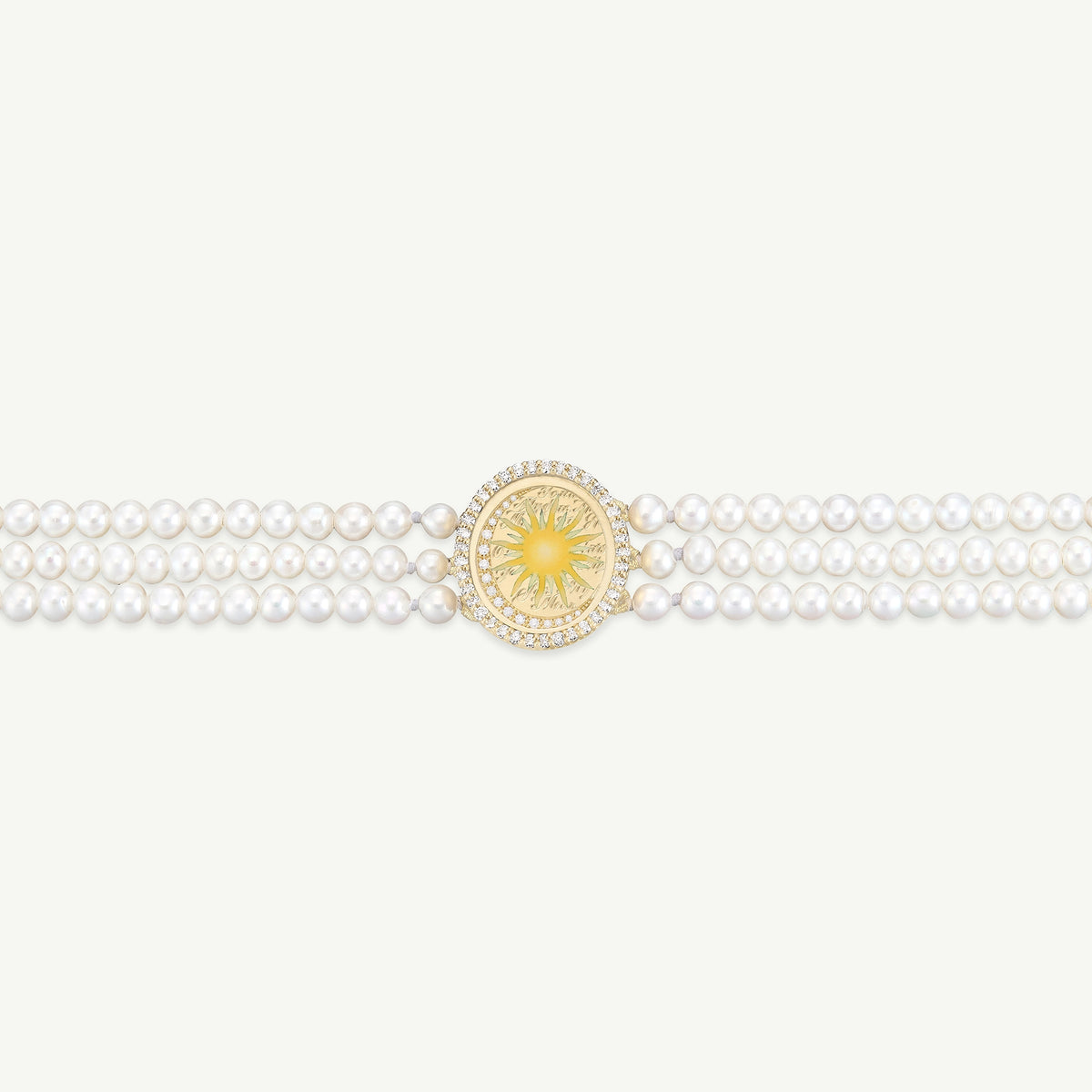 Gold bracelet featuring a sun motif and three strands of pearls surrounding a central golden design.