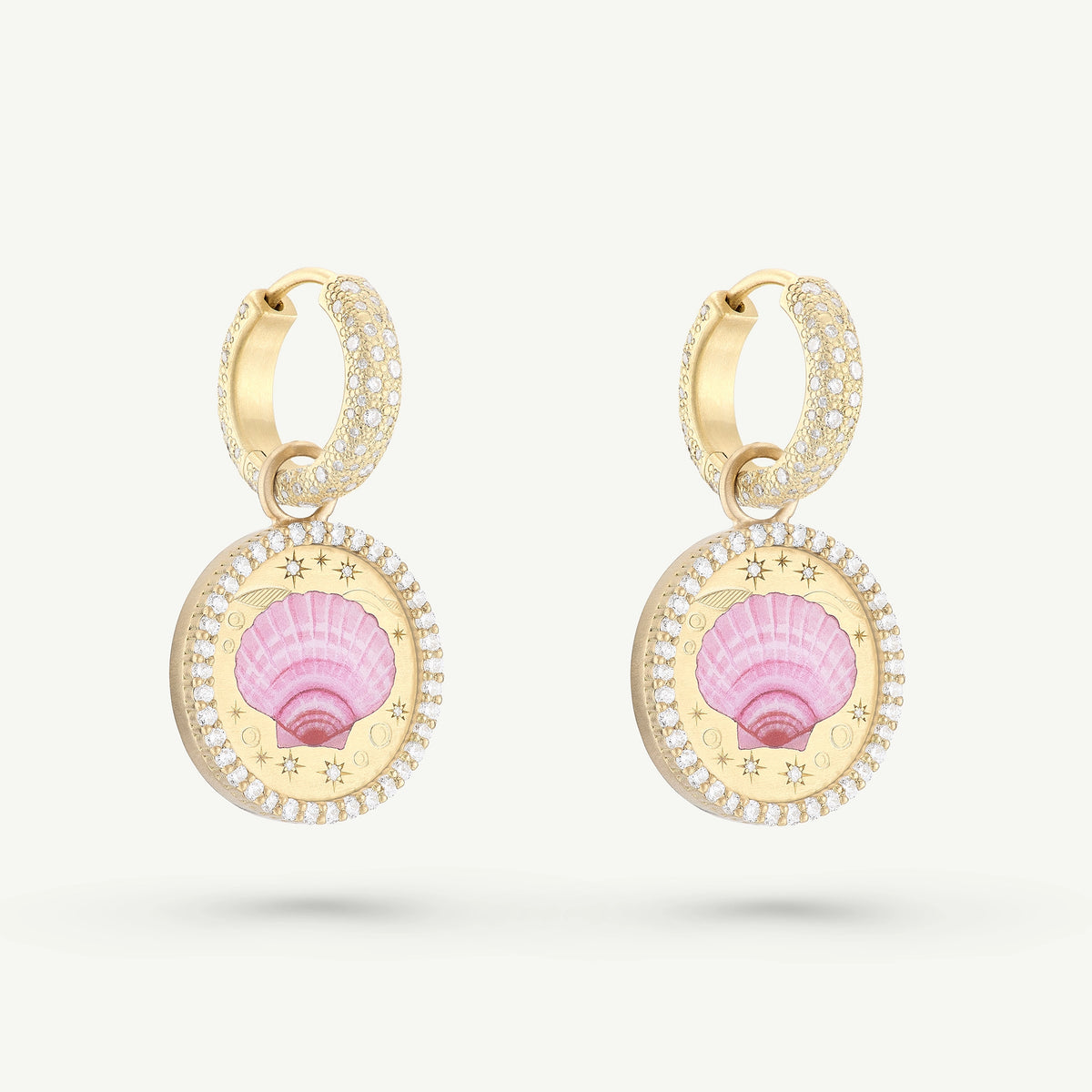 Gold hoop earrings featuring a pink shell motif surrounded by diamonds.