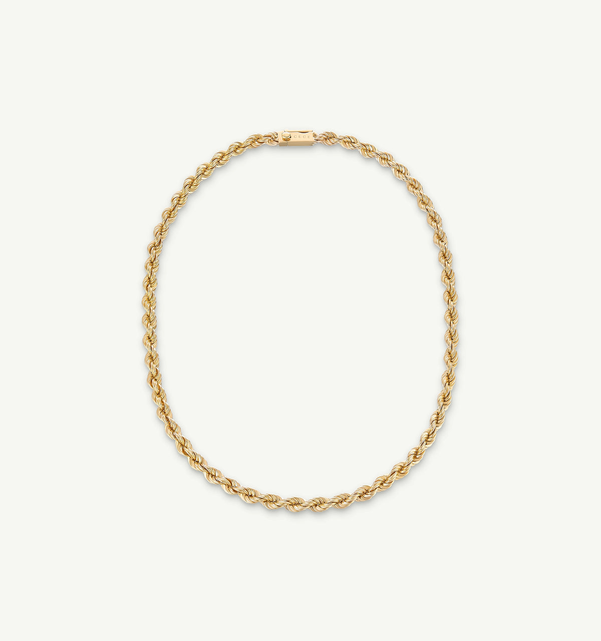 Gold twisted chain necklace on a light background.