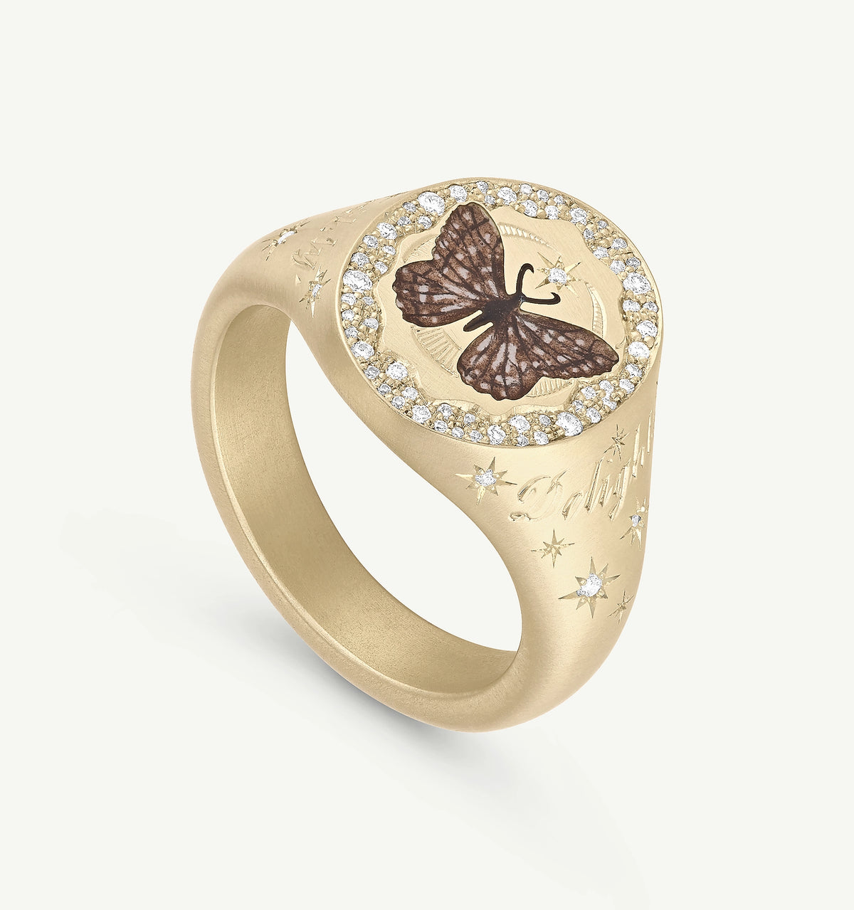 Gold signet ring featuring a butterfly design in enamel and surrounded by diamonds.