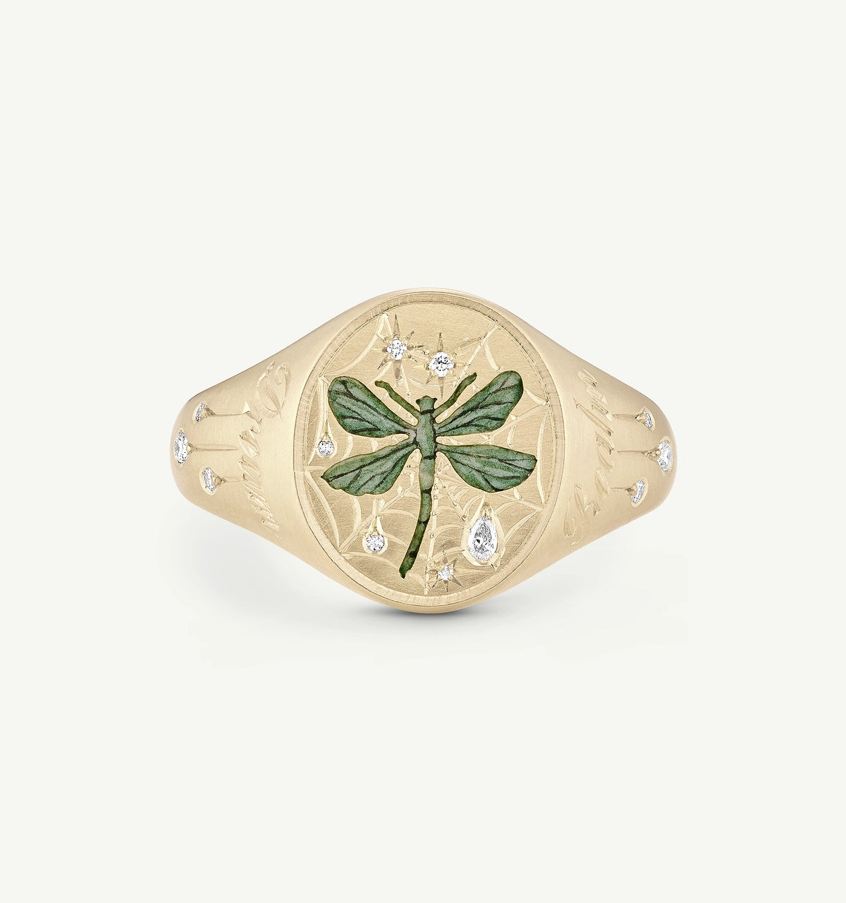 Gold ring featuring an engraved dragonfly design with green enamel and diamond accents.