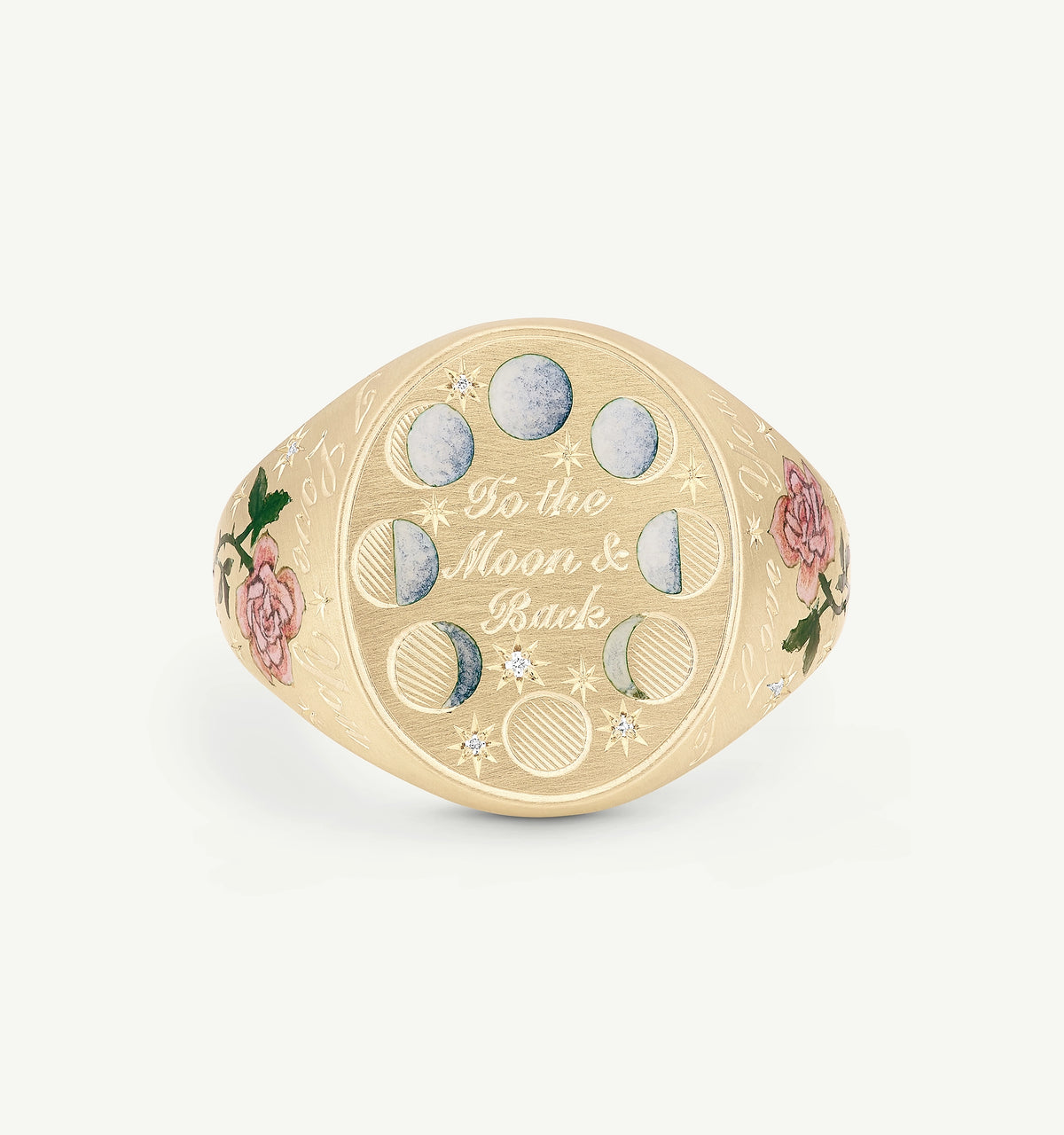 Gold signet ring with engraved moon phases and floral enamel details, featuring "To the Moon & Back" inscription.