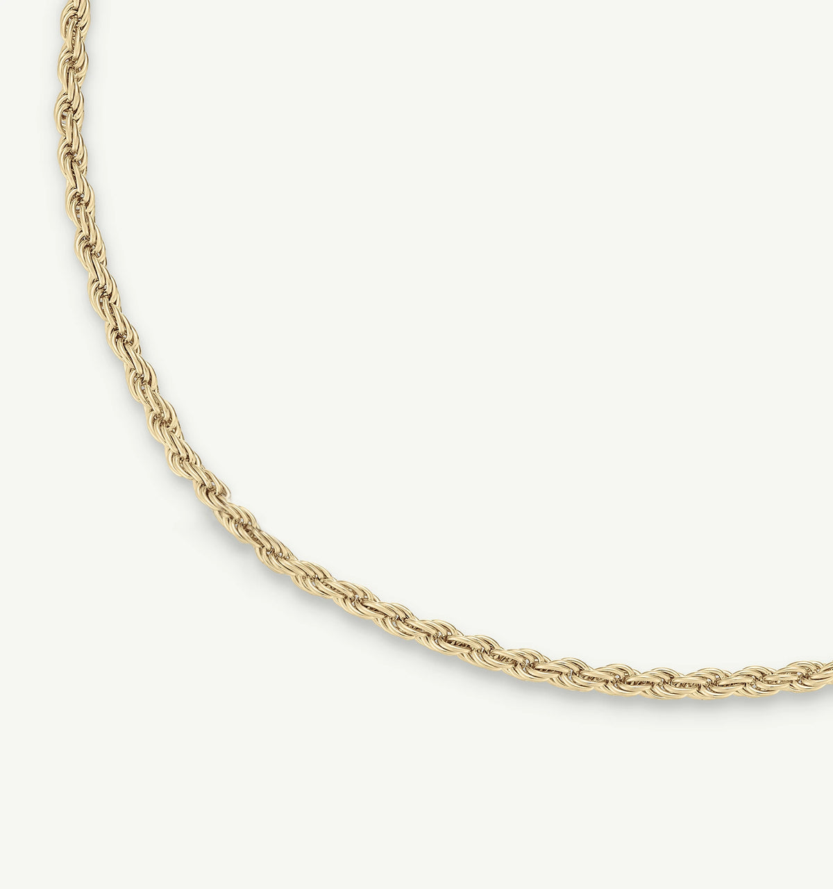 Gold twisted chain necklace on a light background.