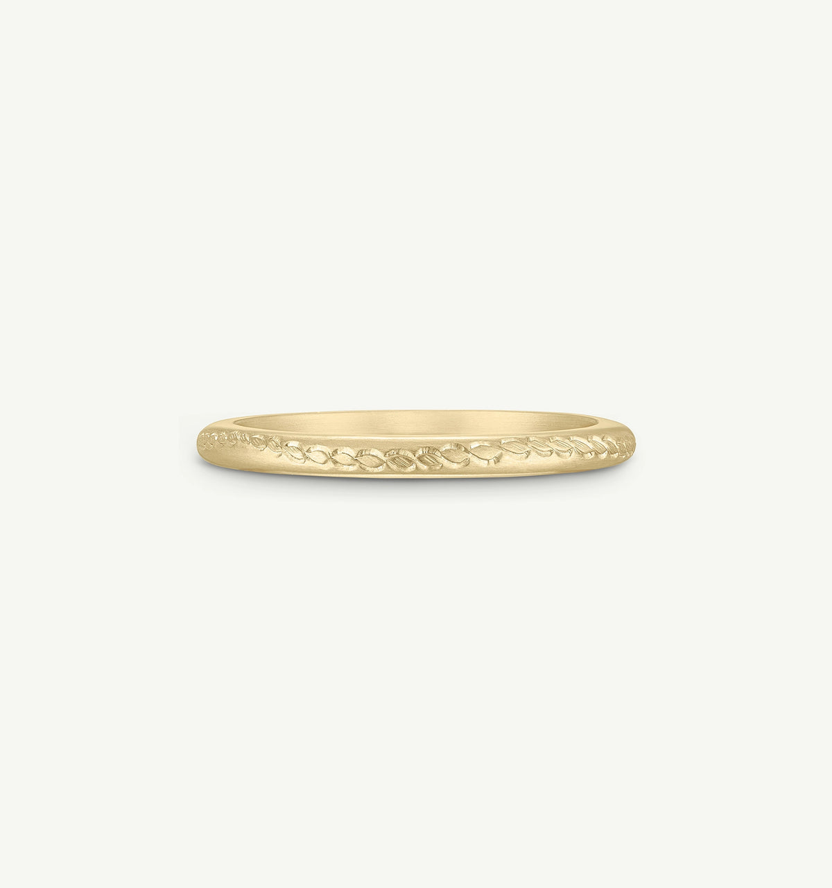 Gold ring featuring an engraved leaf pattern on a smooth band.