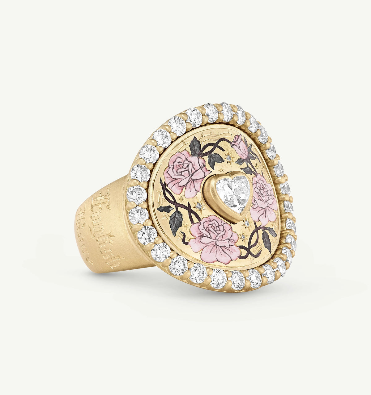 Gold ring featuring a heart-shaped diamond and pink floral enamel design, surrounded by a halo of diamonds.