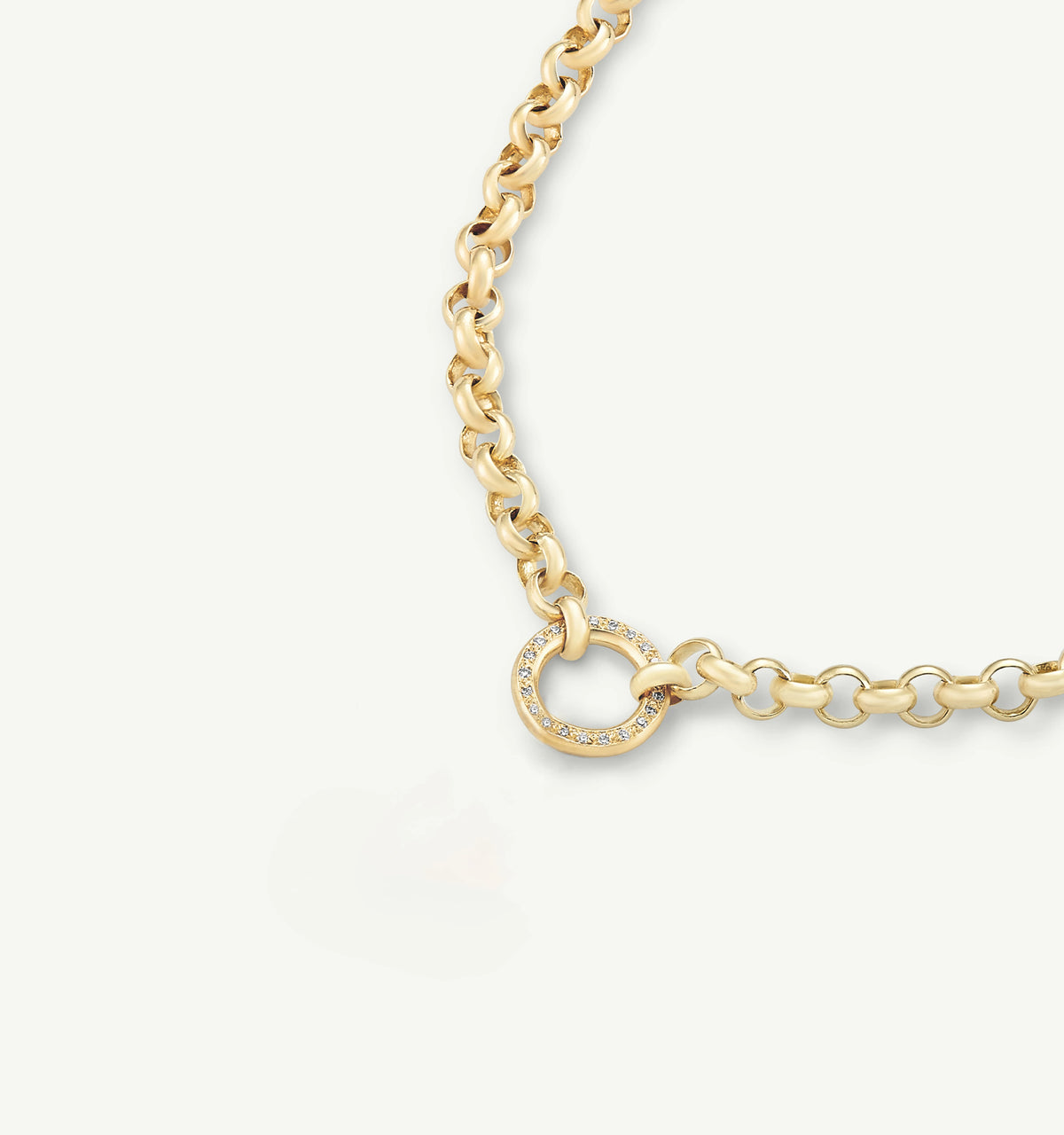 Gold chain necklace featuring a round clasp adorned with small diamonds.