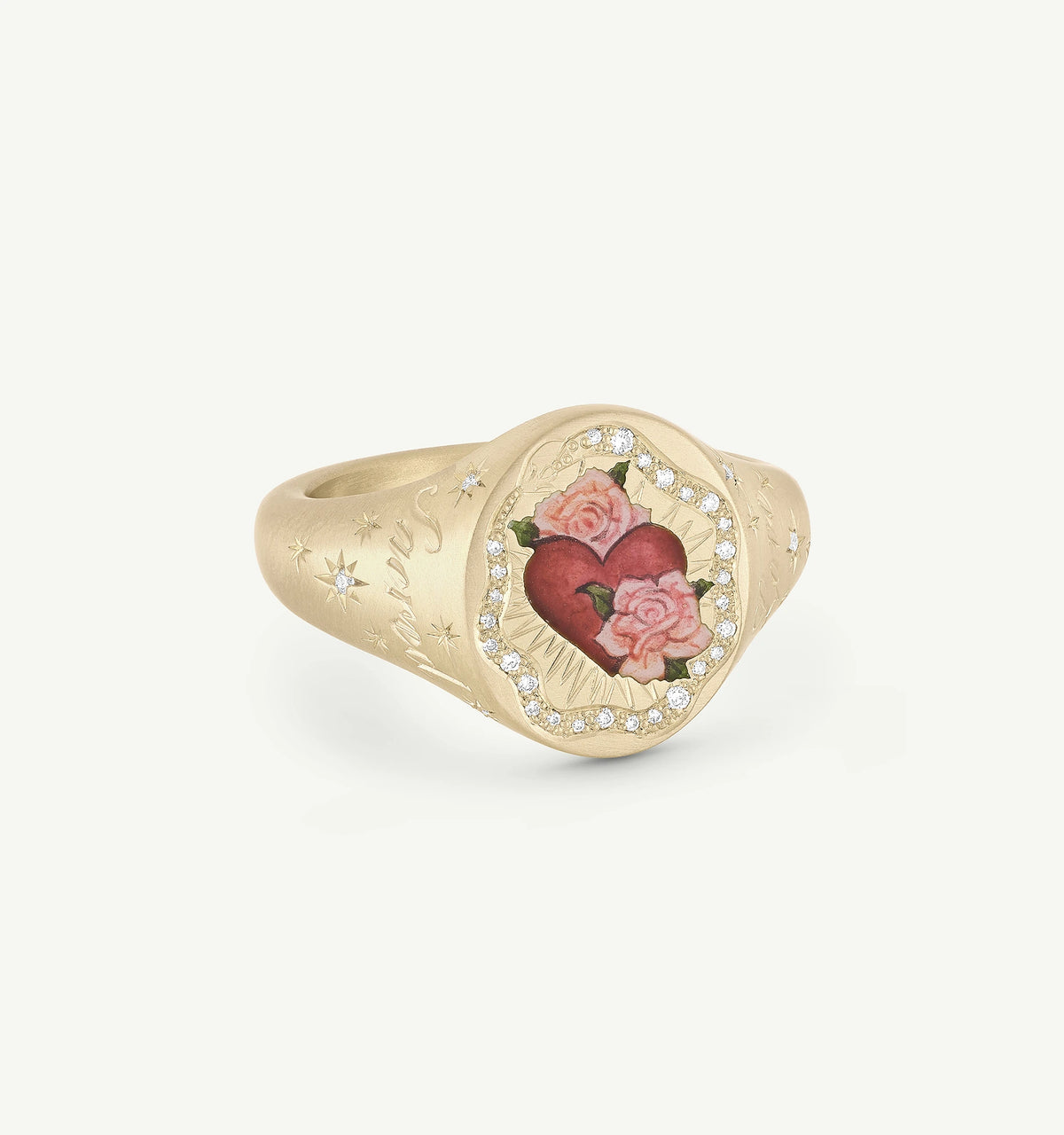 Gold ring featuring a painted heart and roses surrounded by small diamonds, with engraved detailing on the band.