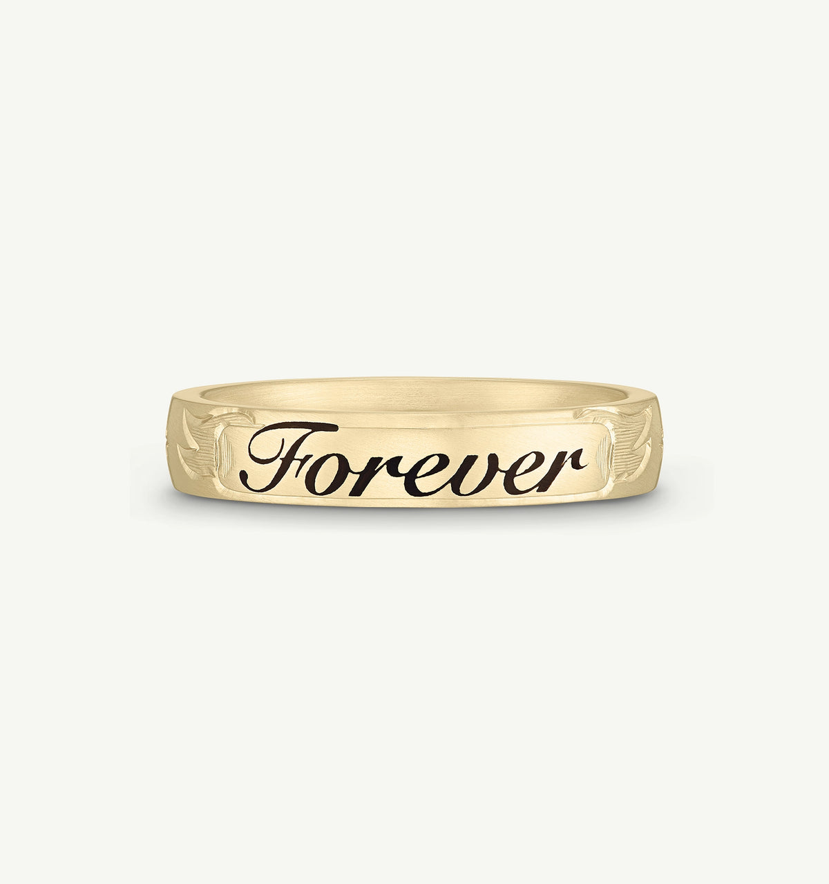 Gold ring featuring engraved “Forever” text and decorative floral motifs.