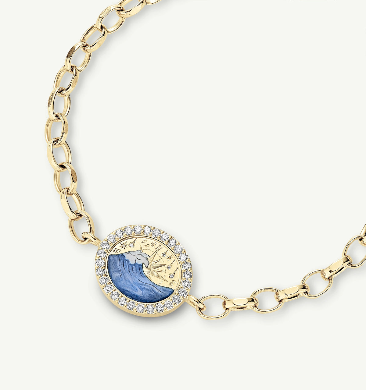 Gold bracelet featuring an oval charm with blue wave design and surrounded by white sapphires.