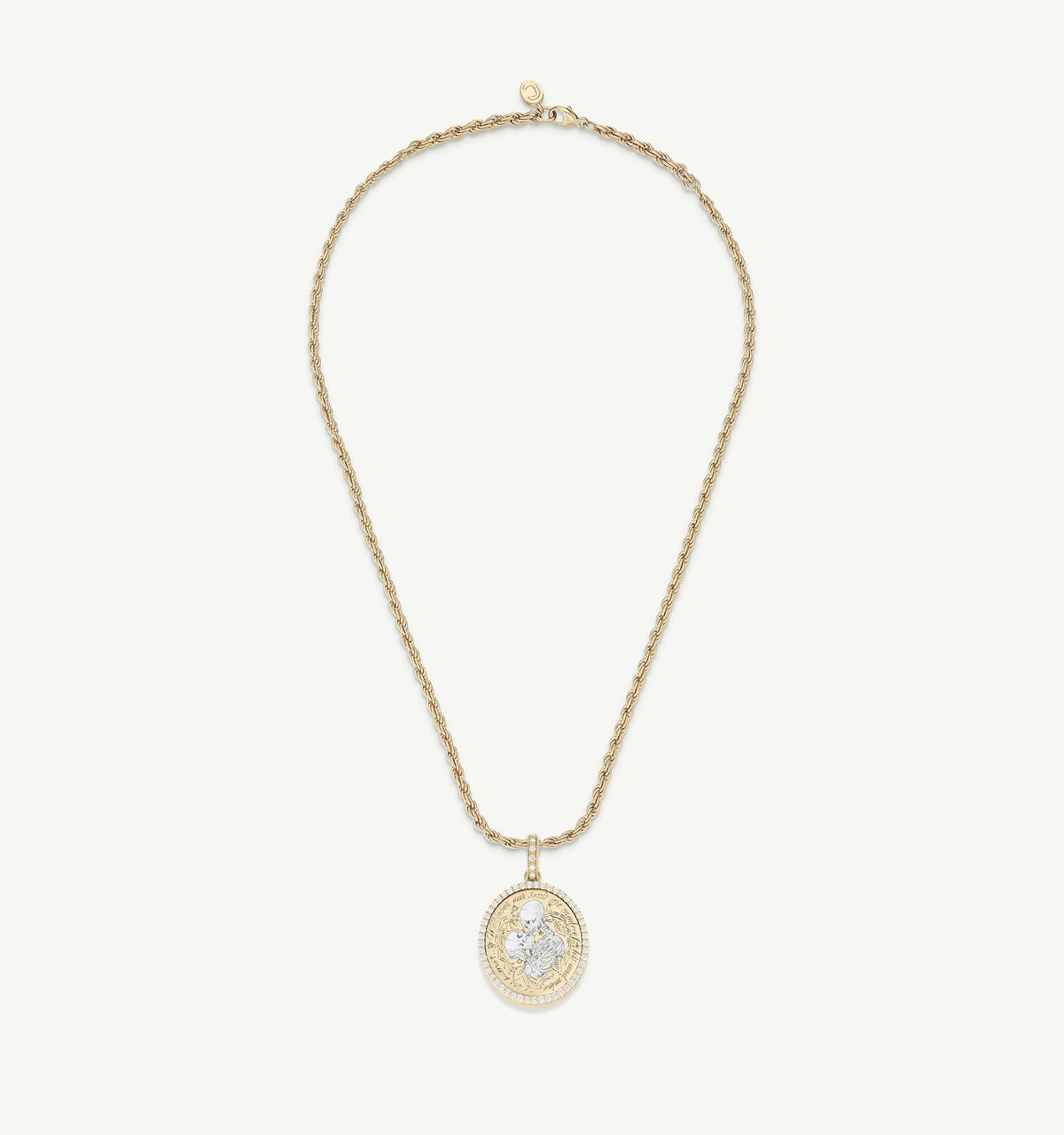 Gold pendant necklace featuring a round charm with engraved design, set on a twisted gold chain.