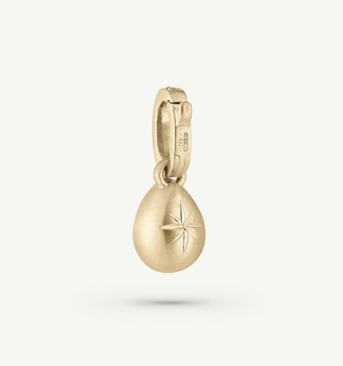 Gold pendant in a teardrop shape featuring an engraved star motif.