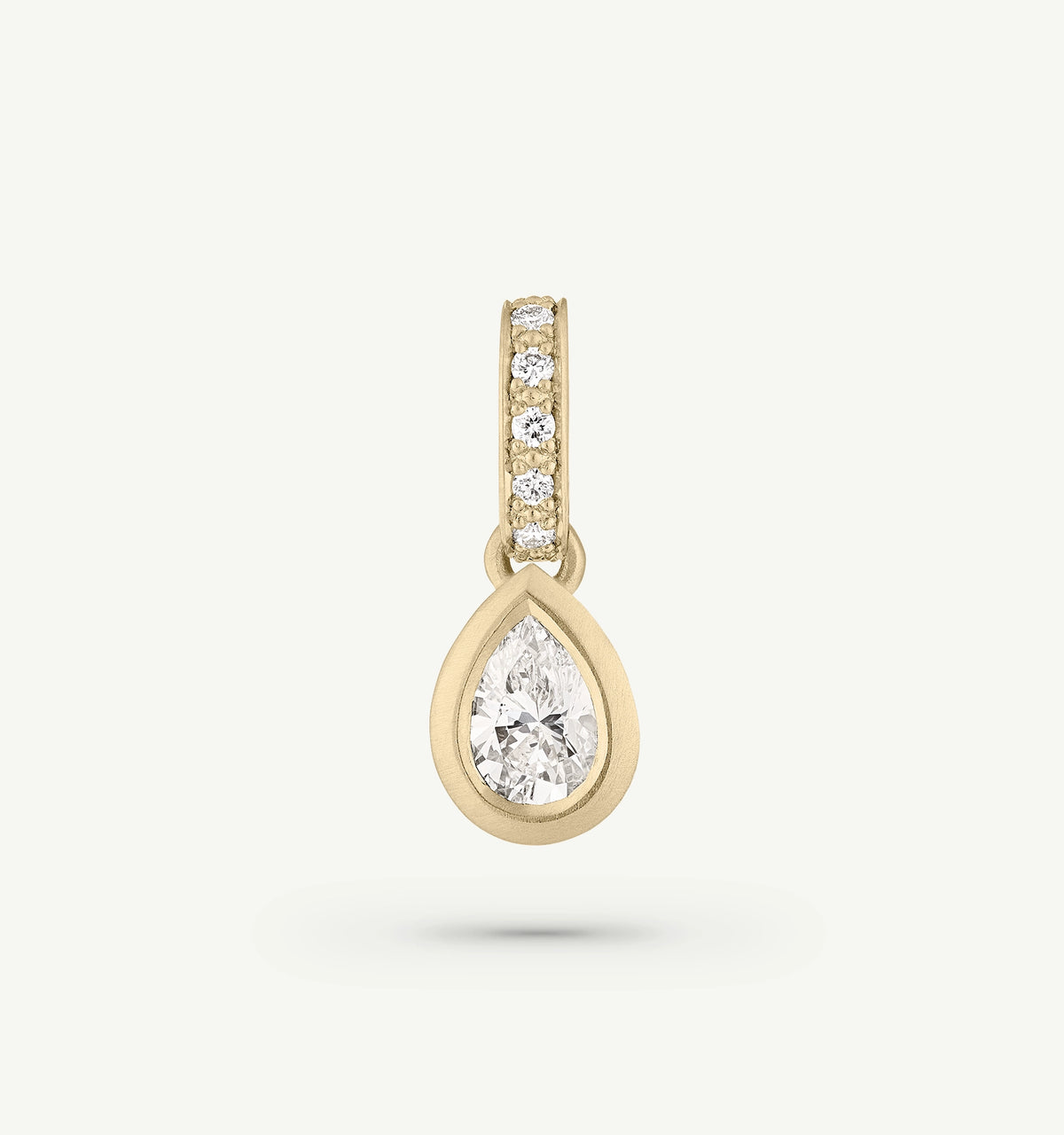 Gold pendant featuring a pear-shaped diamond surrounded by smaller diamonds.