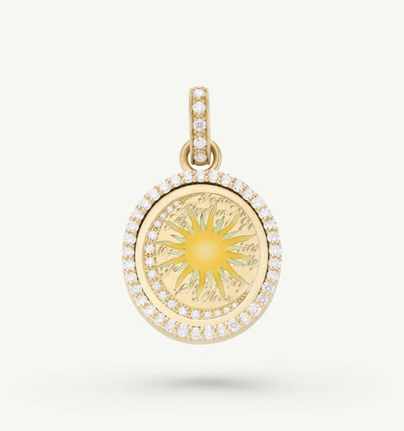 Gold pendant featuring an engraved sun motif surrounded by a halo of round diamonds.