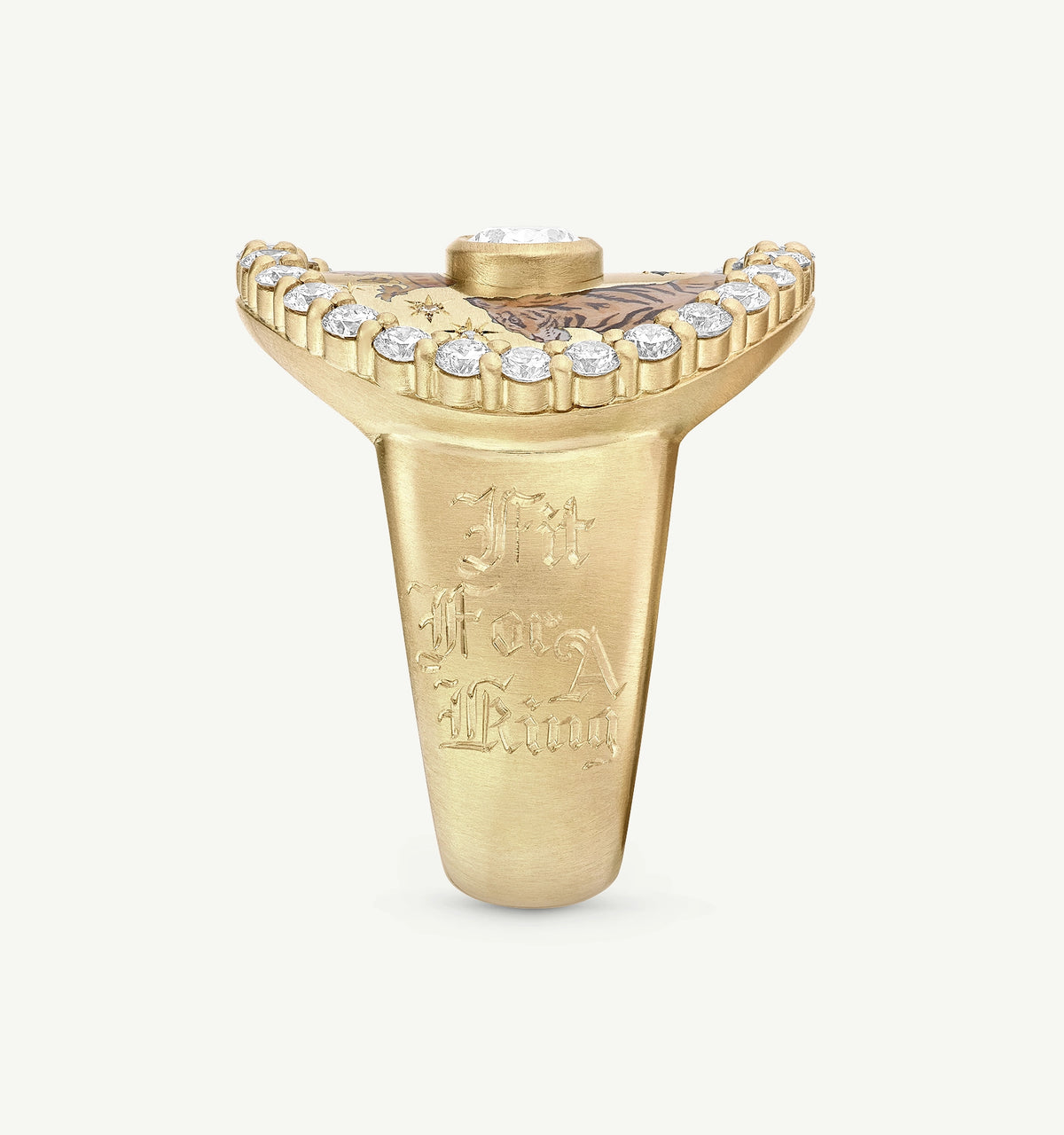 Gold ring with engravings and a row of diamonds along the top edge.