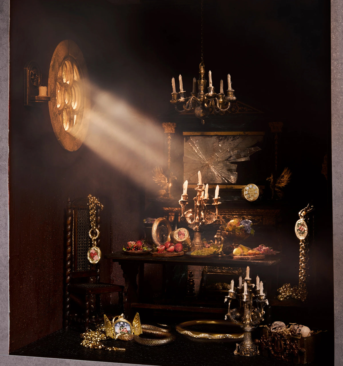 Gold necklace and rings displayed on an antique table, illuminated by soft light filtering through a window.