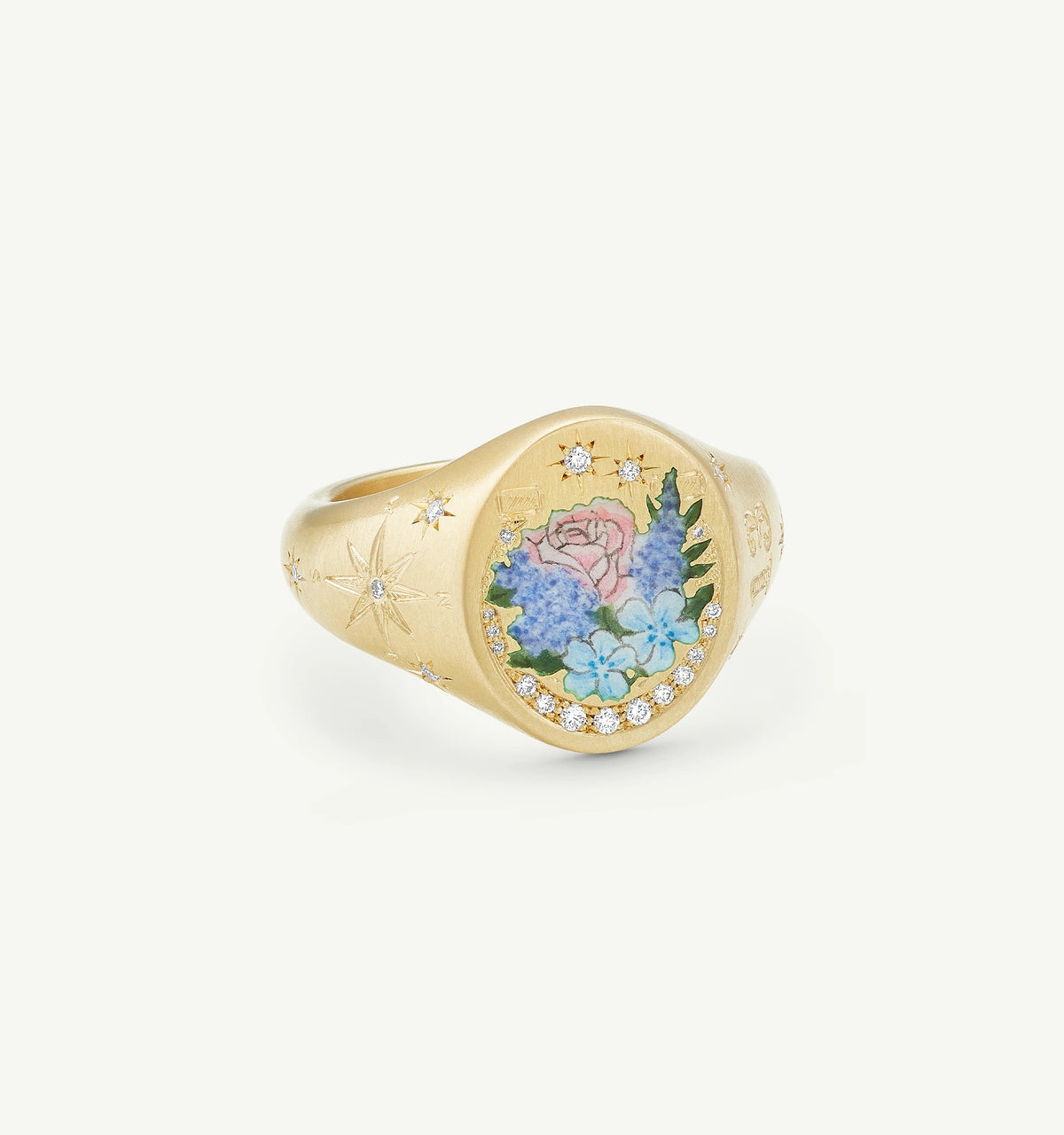 Gold signet ring featuring a colourful floral enamel motif surrounded by small diamonds.