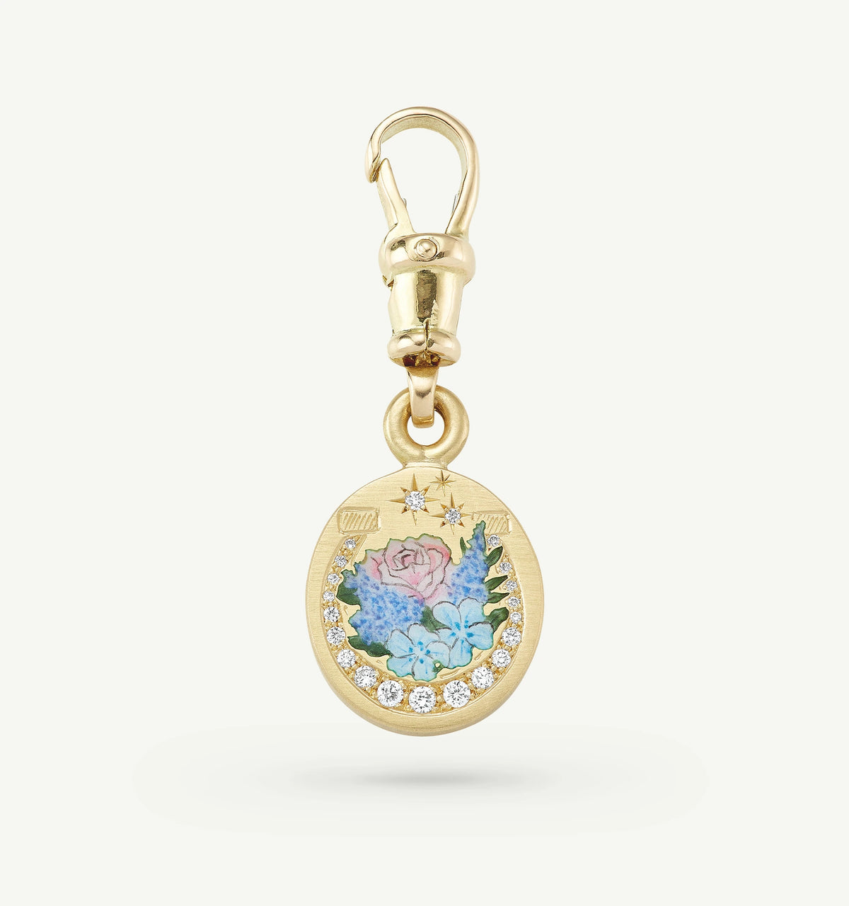 Gold charm with floral enamel artwork and diamond accents, featuring a lobster clasp for attachment.