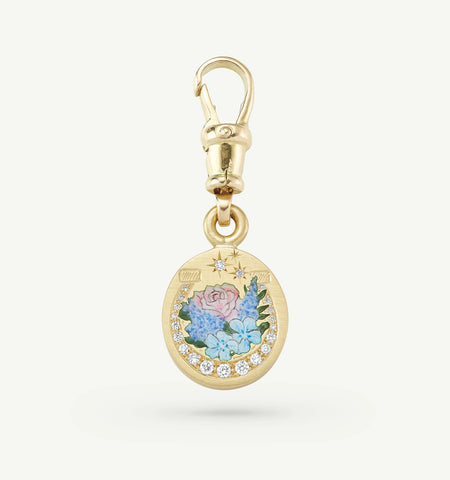 Gold charm with floral enamel artwork and diamond accents, featuring a lobster clasp for attachment.